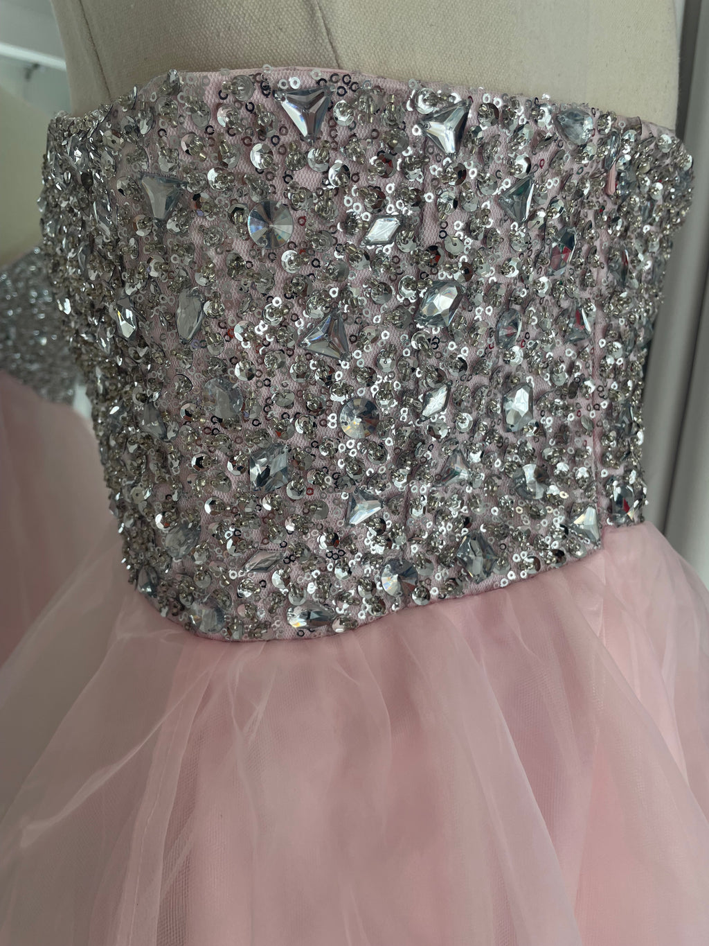 Mini pink strapless tulle party dress with a diamante, crystal, gem, sequin bust. close up of diamante gems