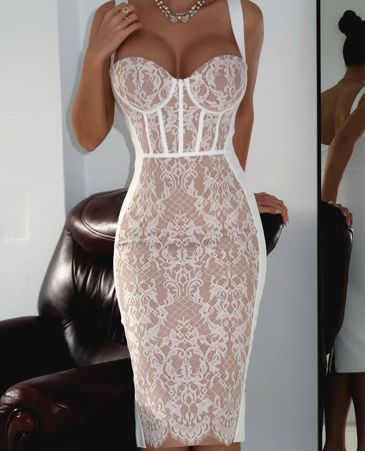 Bella Barnett lace bodycon bandage midi dress. corset stye and padded bust. Dress displayed on a model 