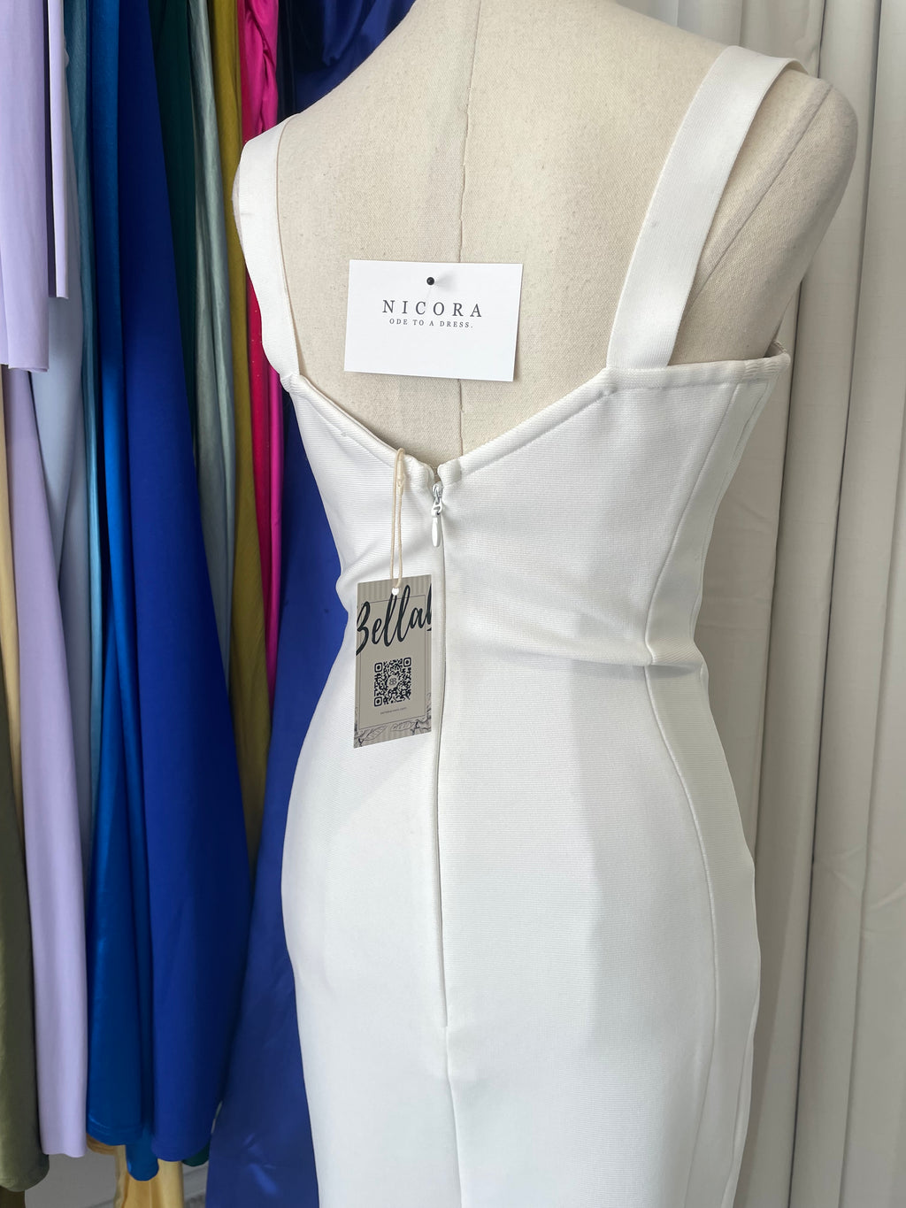 Bella Barnett lace bodycon bandage midi dress. corset stye and padded bust. Dress displayed on a mannequin. back view 