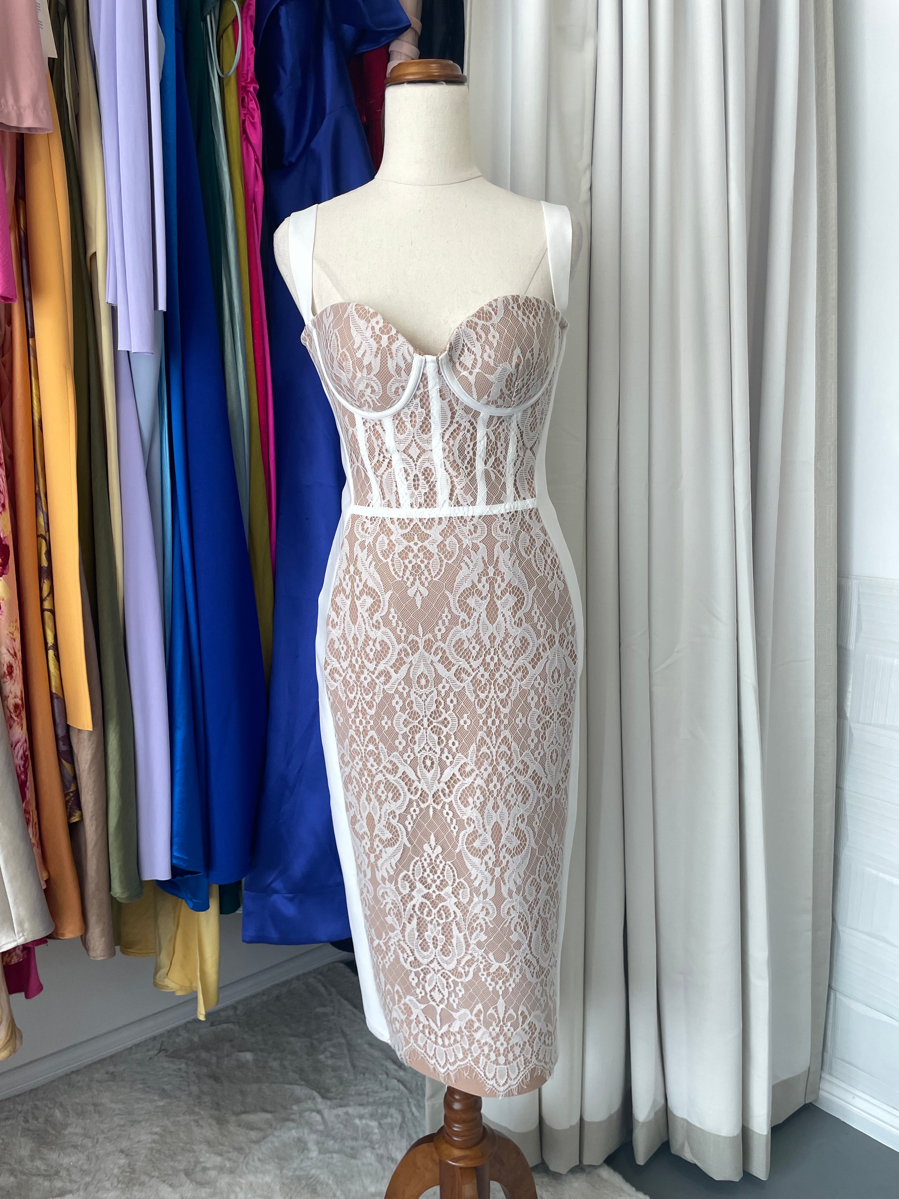 Bella Barnett lace bodycon bandage midi dress. corset stye and padded bust. Dress displayed on a mannequin