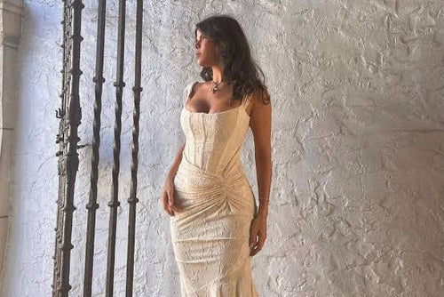 Sophisticated stretch jacquard dress with delicate floral detailing. Features a boned bodice, adjustable straps, and striking bare back. The high-waisted mermaid skirt with thigh slit creates an elegant silhouette, finished with a discreet back zipper.