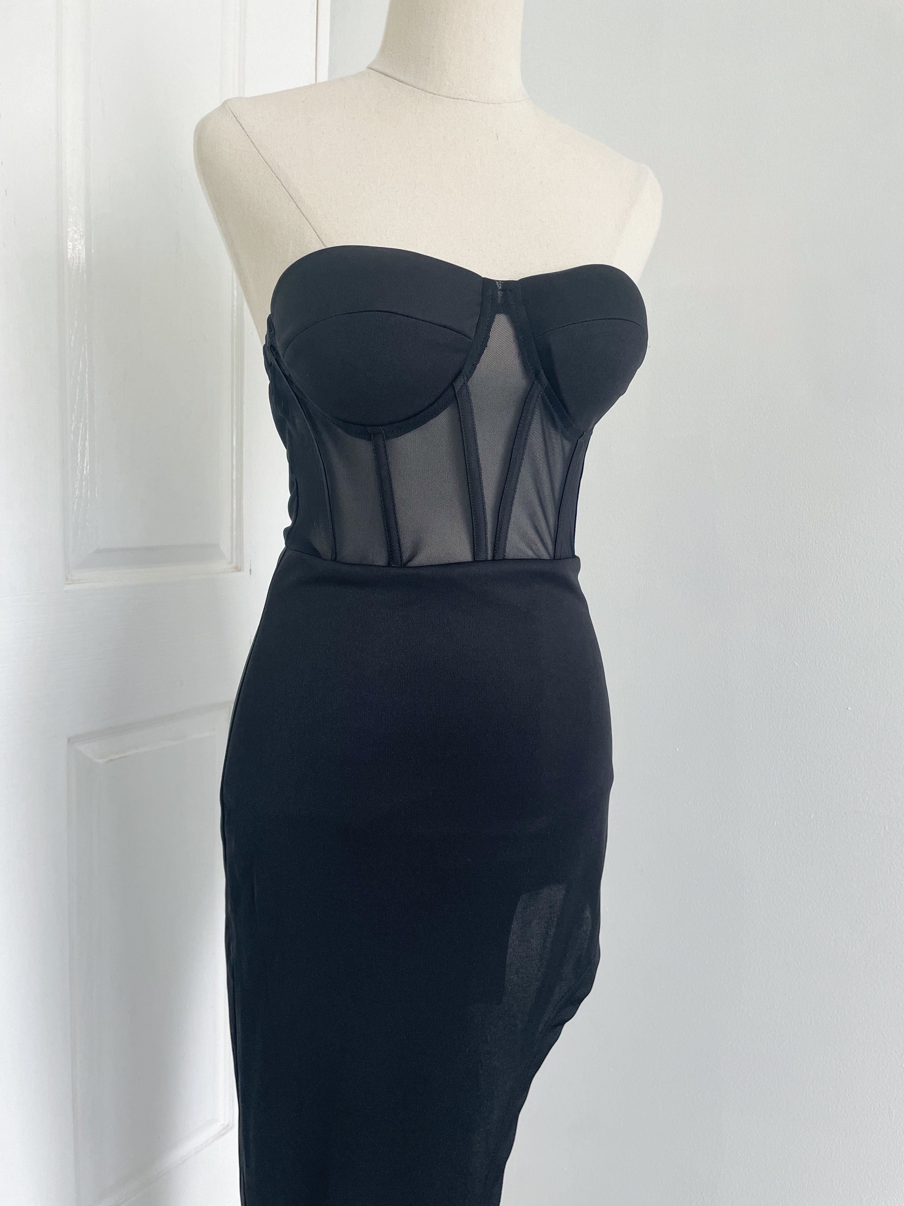 a strapless corset black dress with a high side slit. An upclose image of corset mesh dress