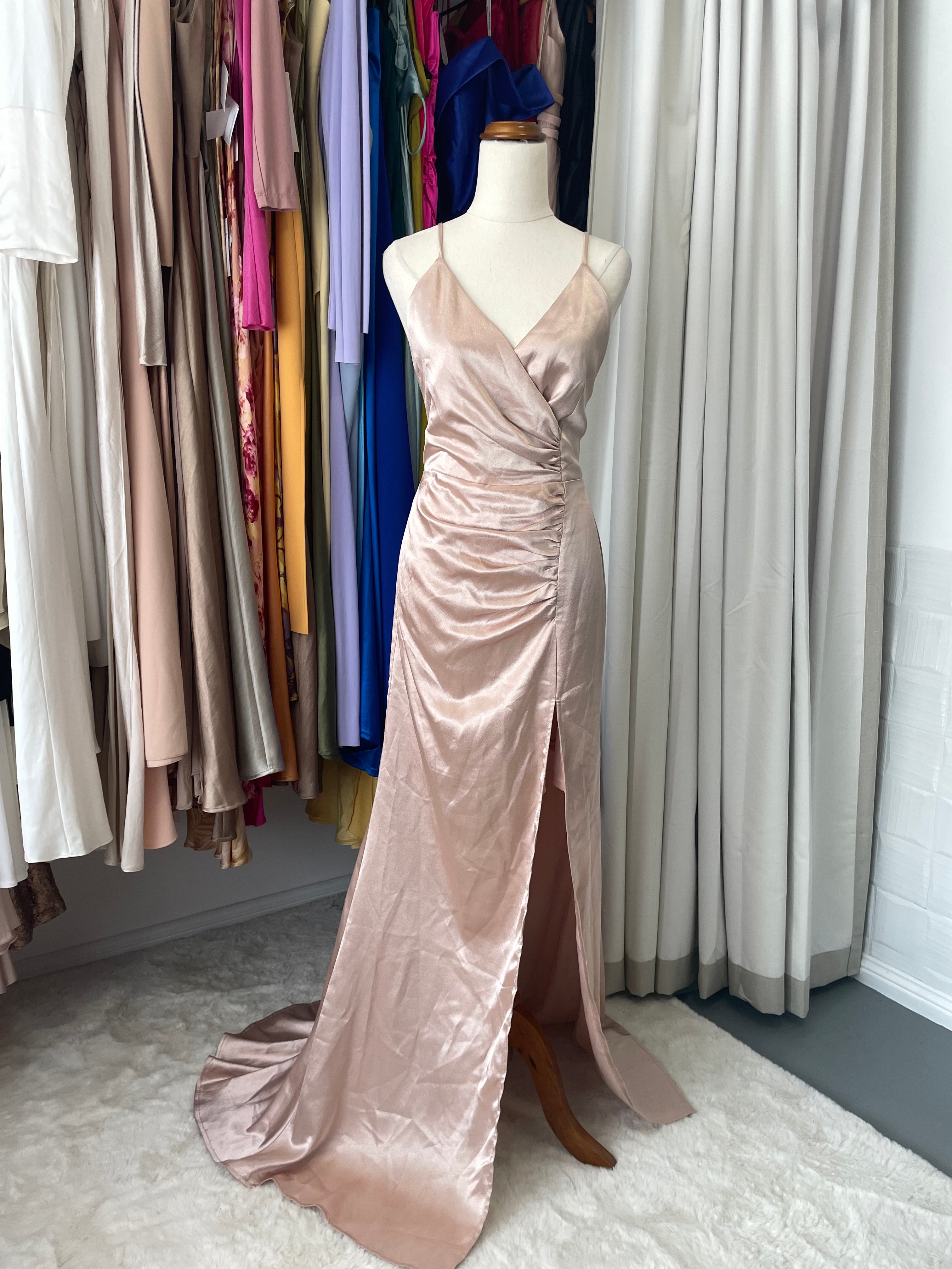 This gorgeous rose gold maxi dress strikes the perfect balance between polished and fun, with chic side ruching that hugs you in all the right ways. A bold high leg split keeps things interesting with a dash of modern edge, while the flowing drape works its magic to elongate and flatter your frame beautifully.