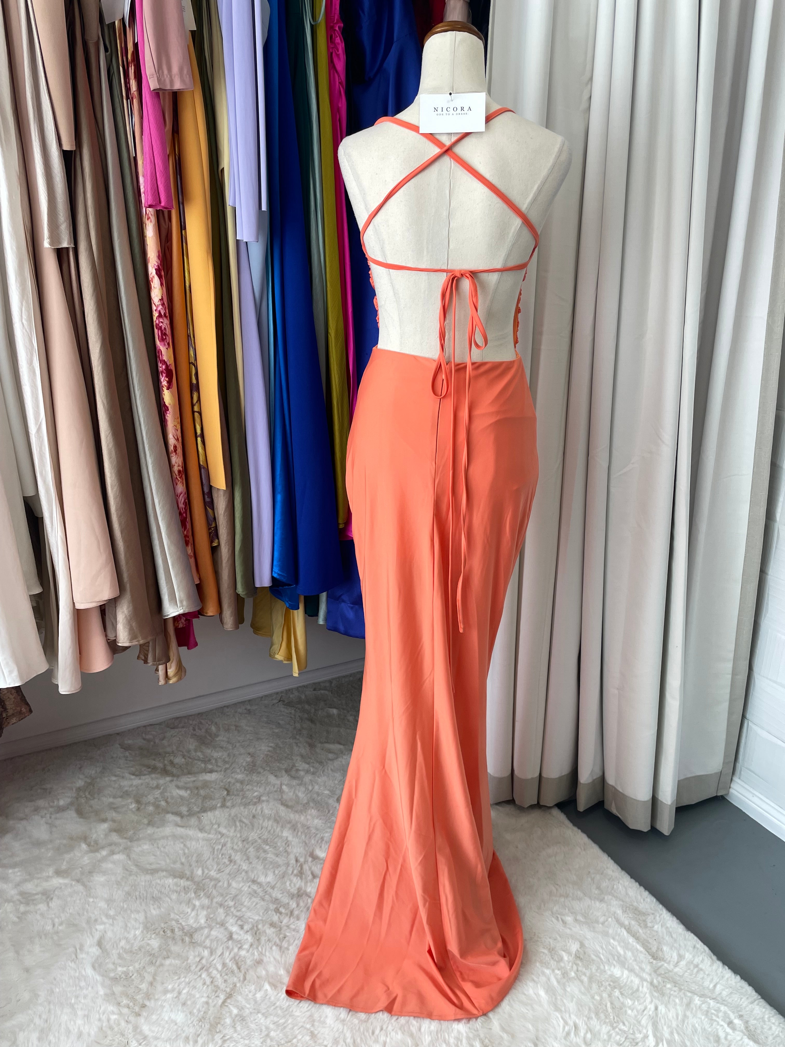 back view of Miss Ord coral gown, backless halter neck style dress with leg split, 