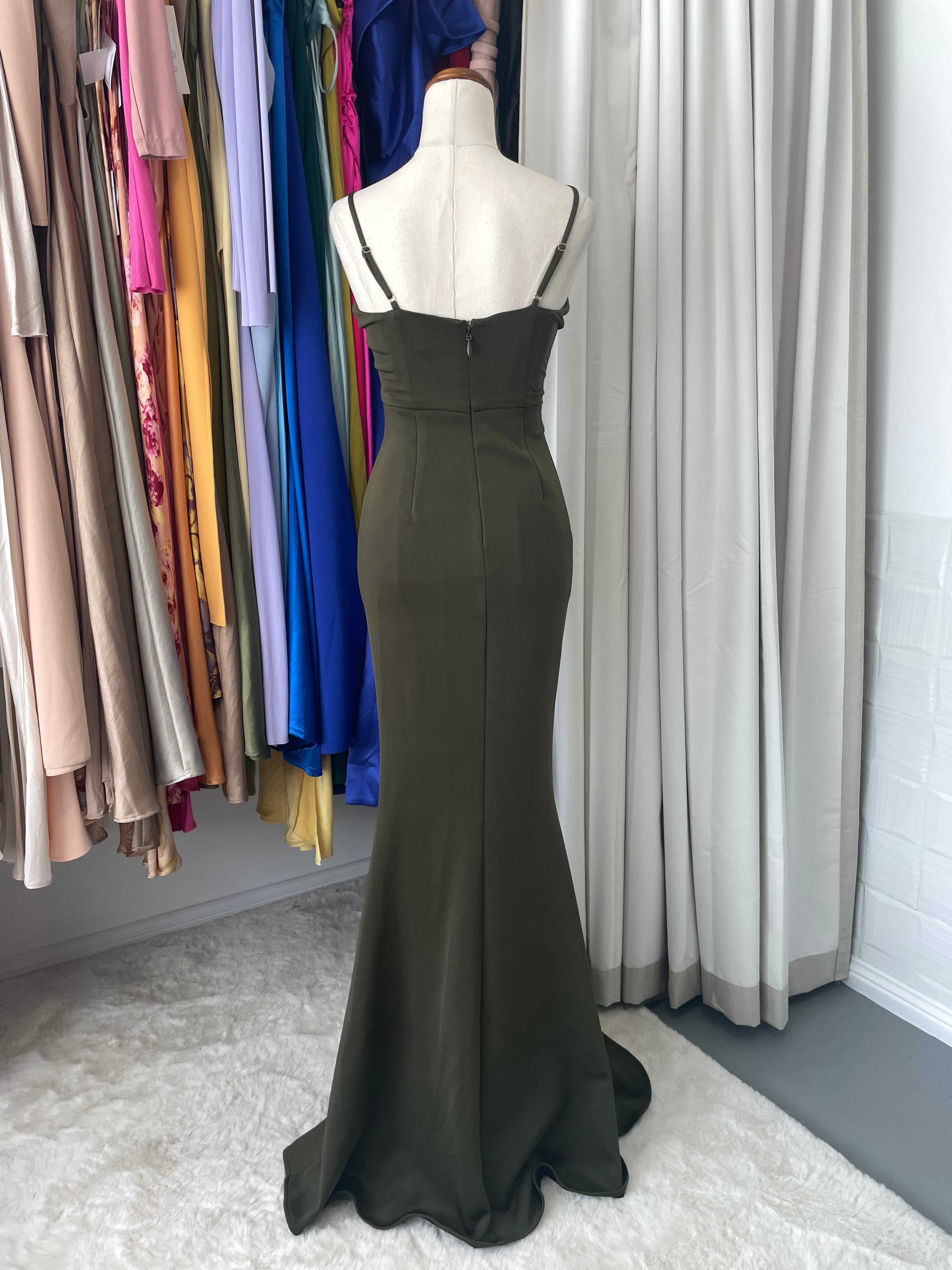 This Sheike piece delivers understated edge with practical style. Customizable straps and a concealed back zipper offer versatility, while the stretchy fabric moves with your body. The standout waist detailing creates dimension and shape, enhanced by a subtle mermaid hem that adds just enough curve without overdoing it.