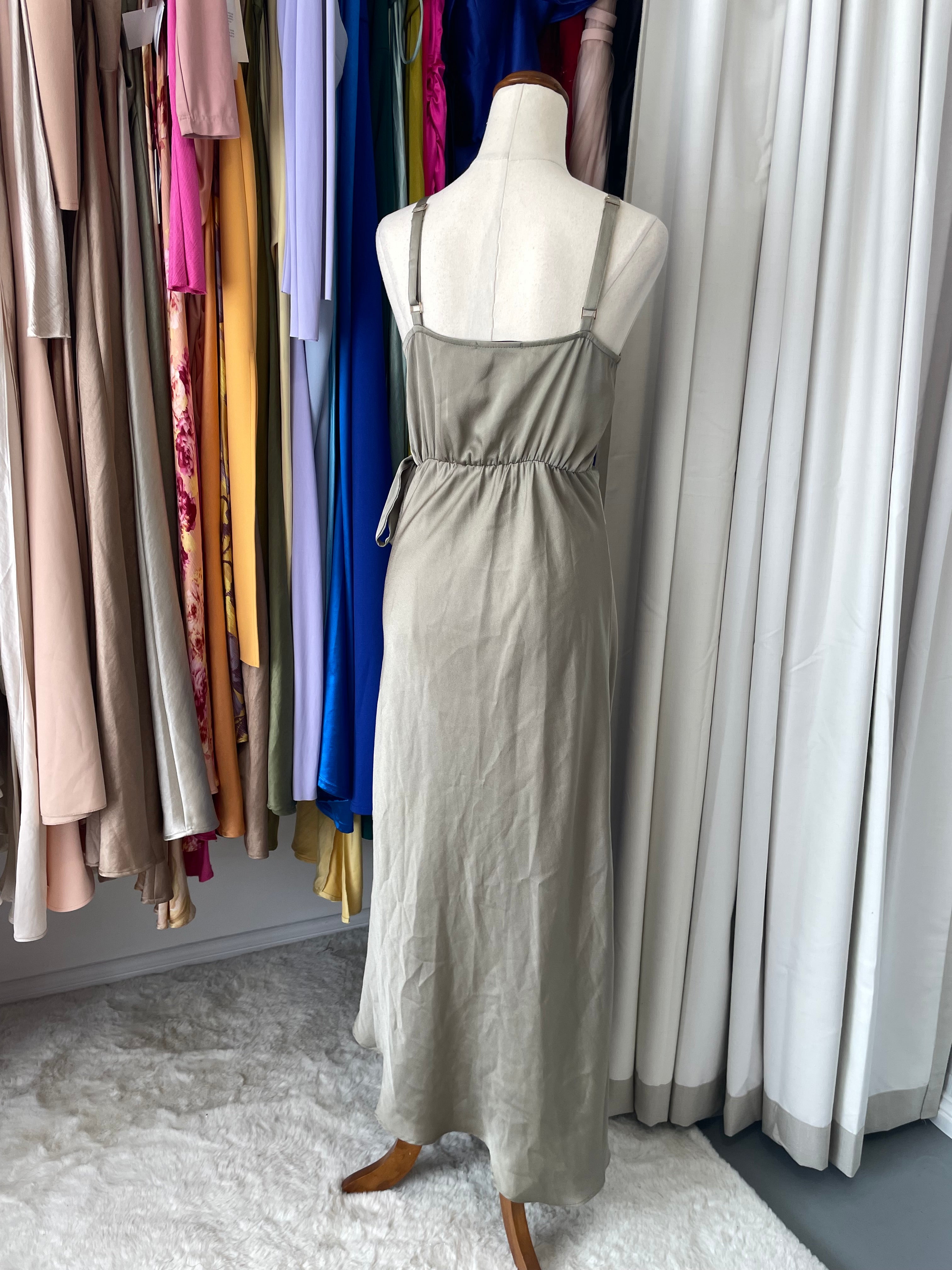 a mannequin wearing an olive maxi dress
