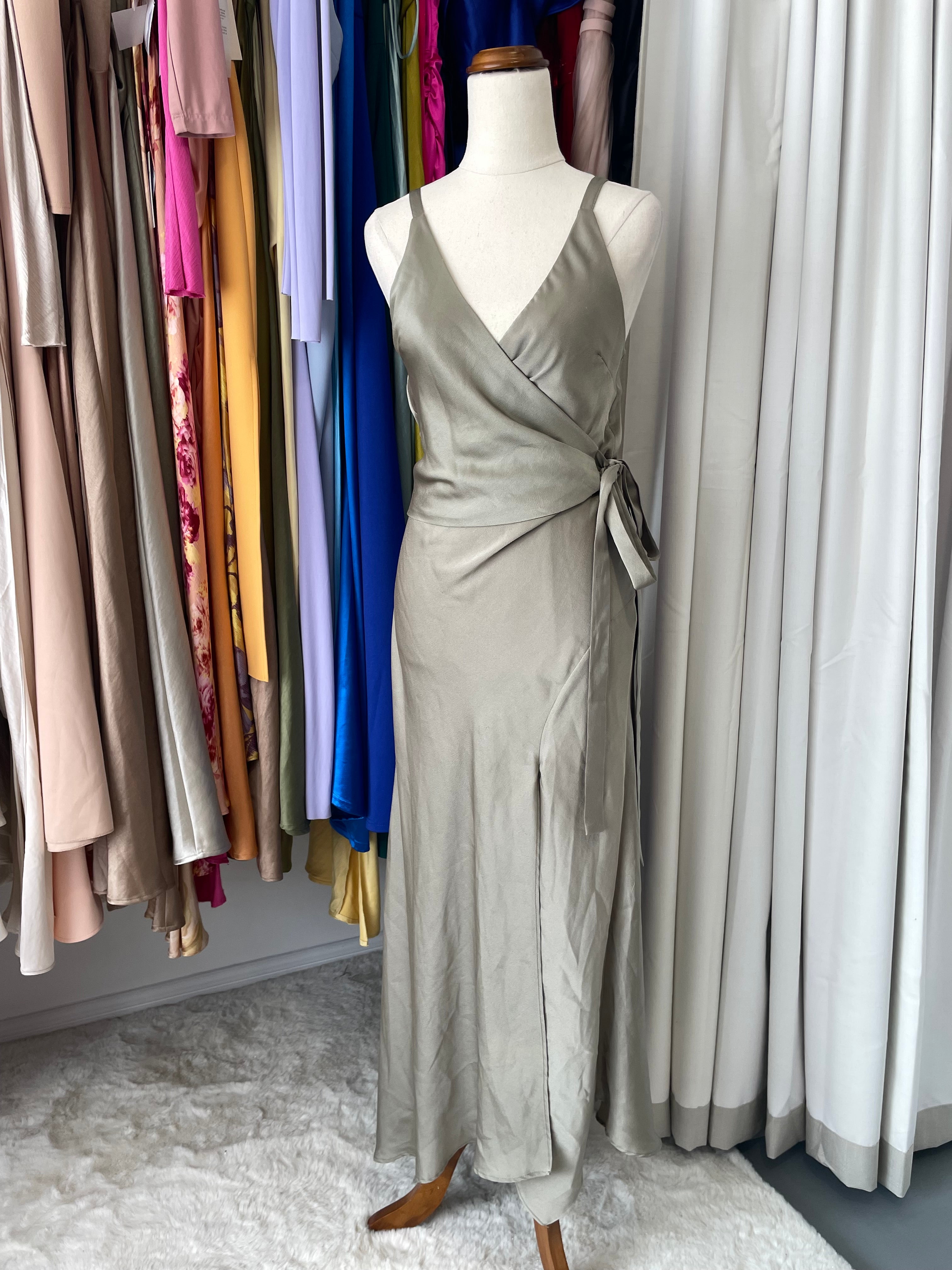 A mannequin wearing an olive green wrap dress front view 