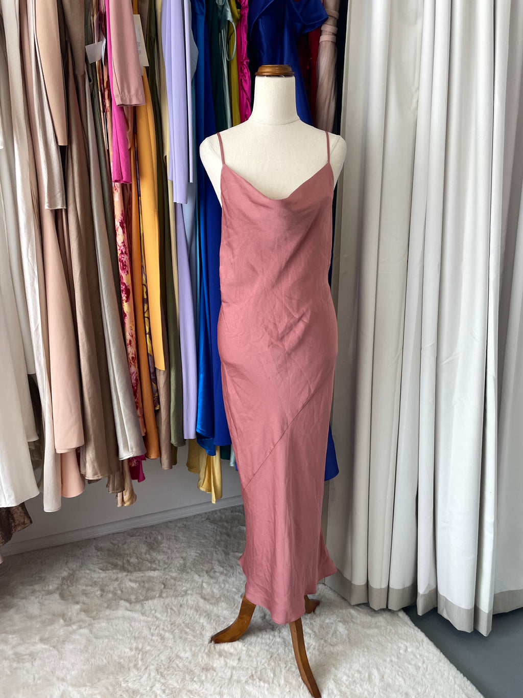 Mannequin wearing a pink dress in a boutique 
