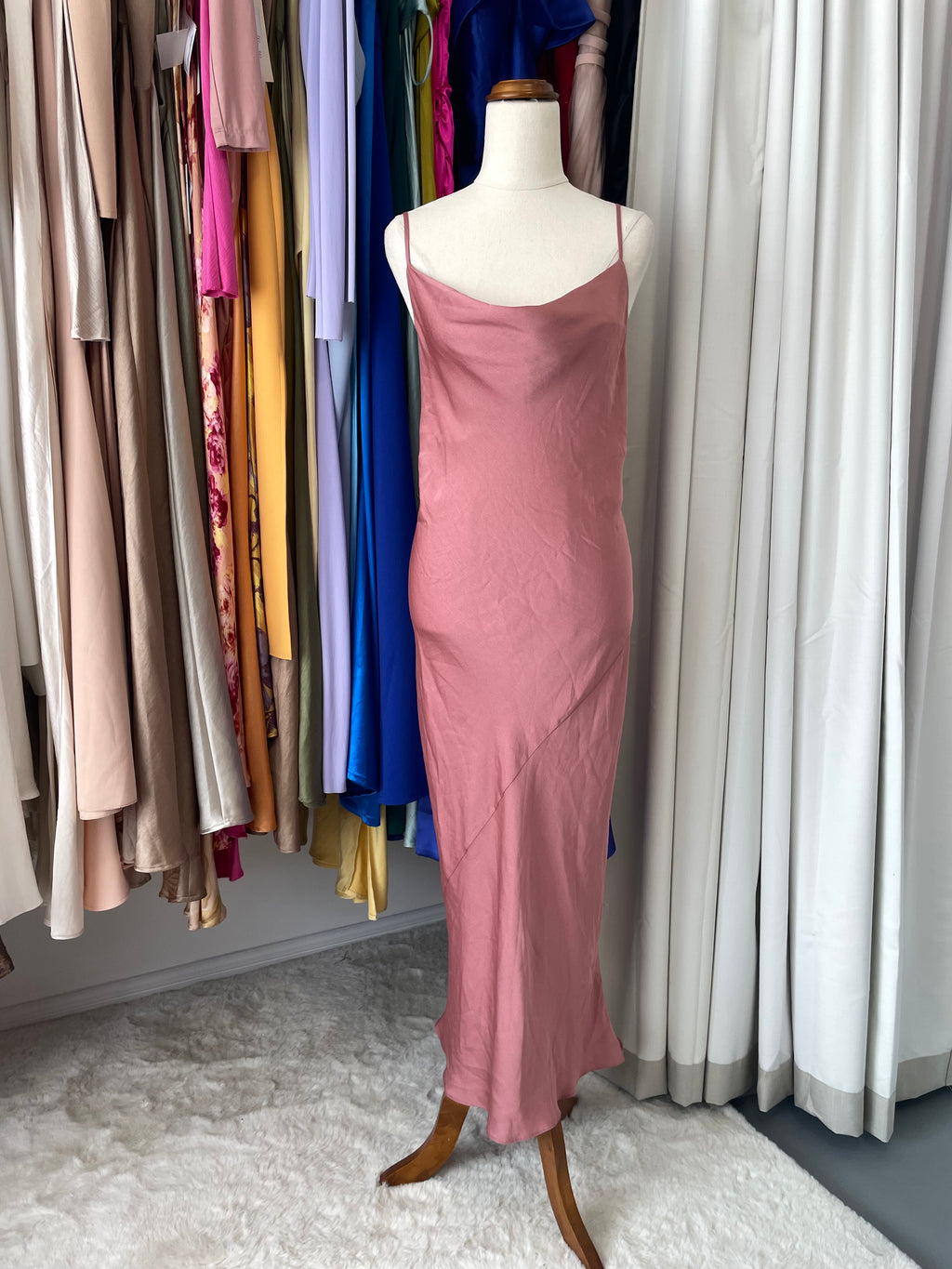 Mannequin wearing a pink dress in a boutique