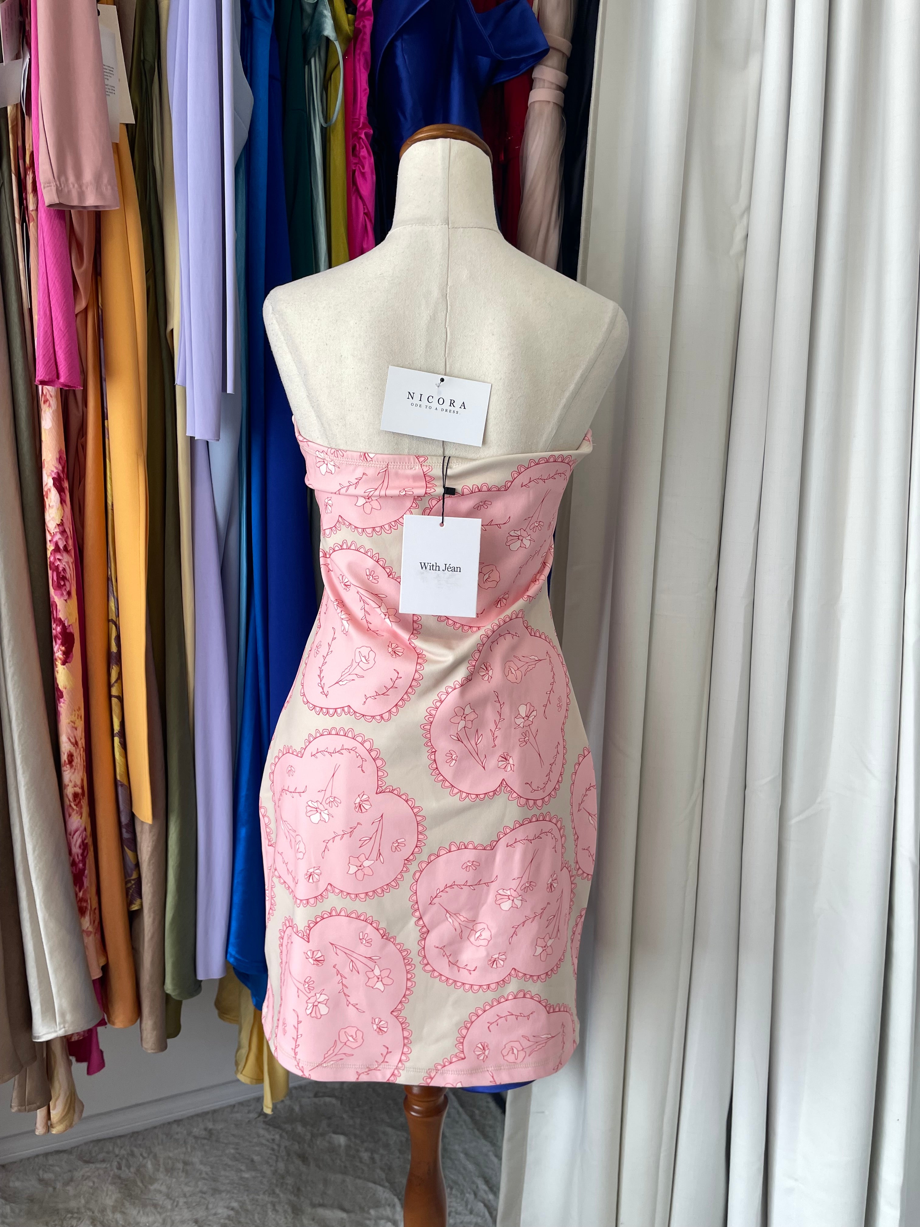Mannequin wearing a dress with pink floral patterns 