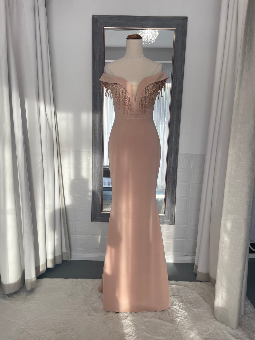 Apricot body con formal dress. floor length off the shoulder and deep v chest with dangling bead detail 