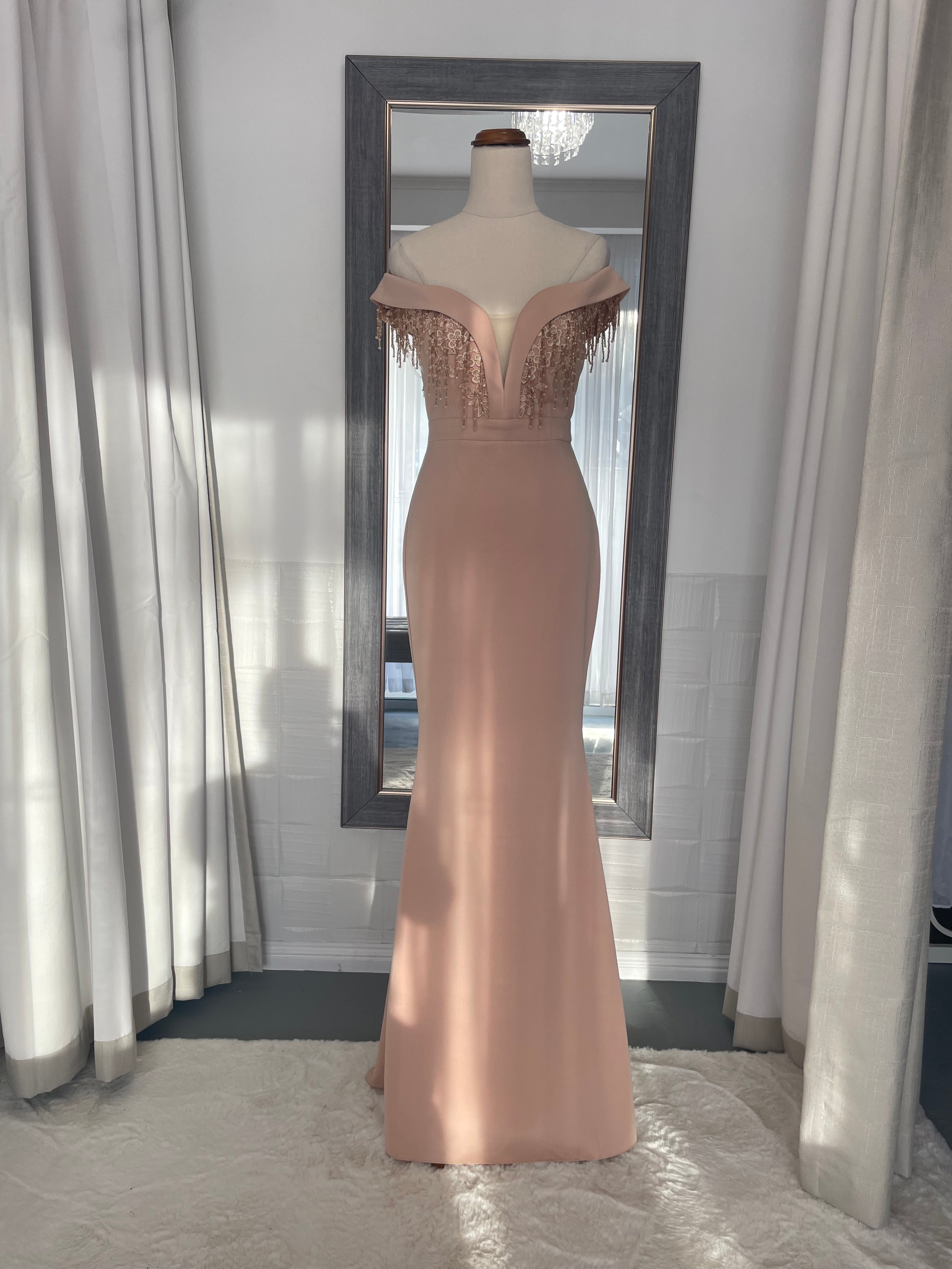 Apricot body con formal dress. floor length off the shoulder and deep v chest with dangling bead detail 