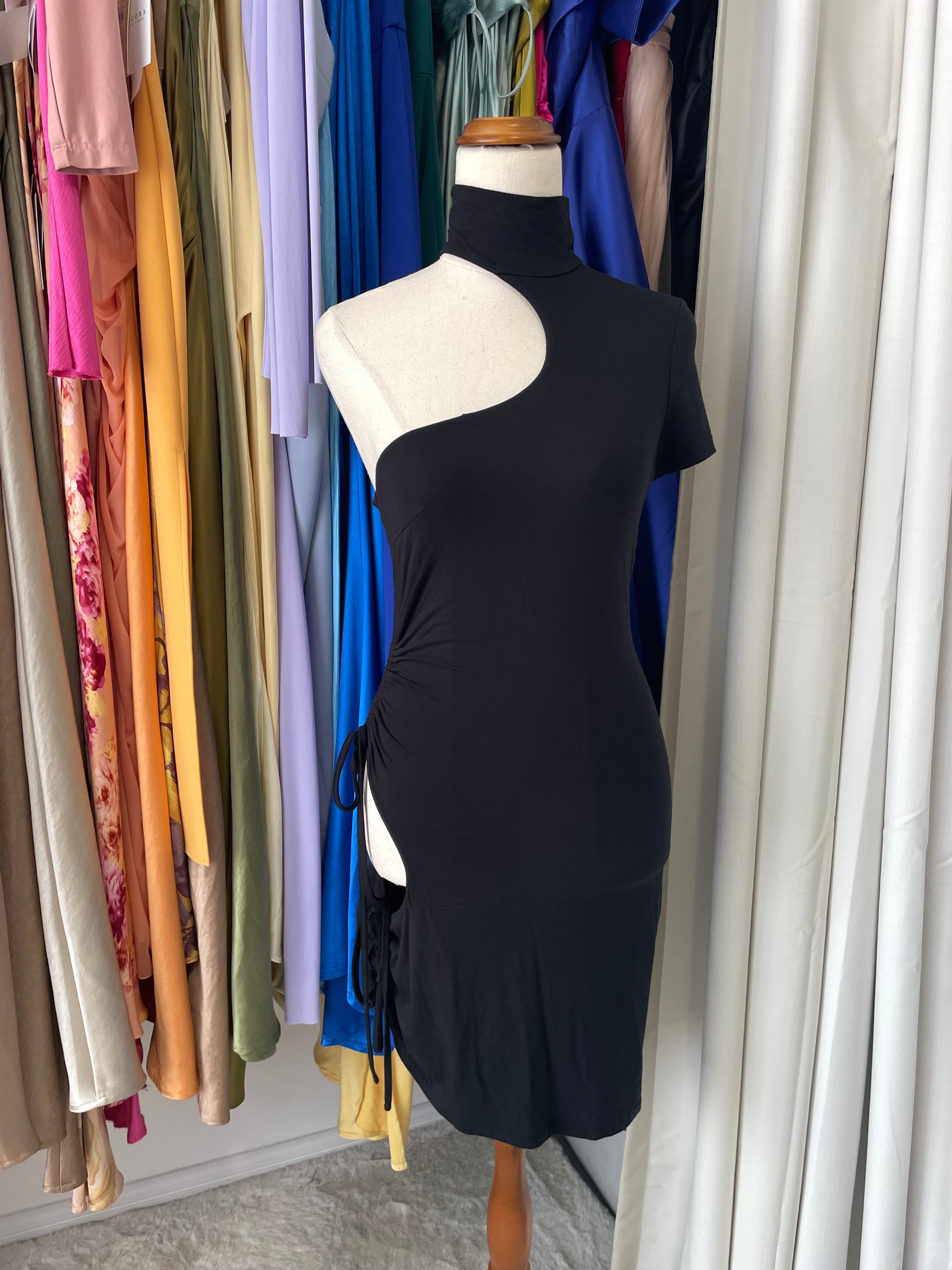 Stack of colorful fabric swatches with a black fabric swatch on top.